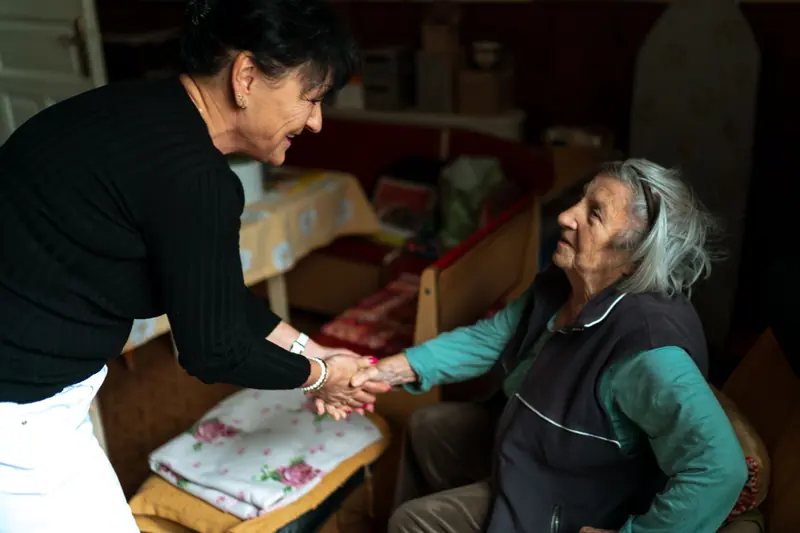 A caregiver greeting a resident