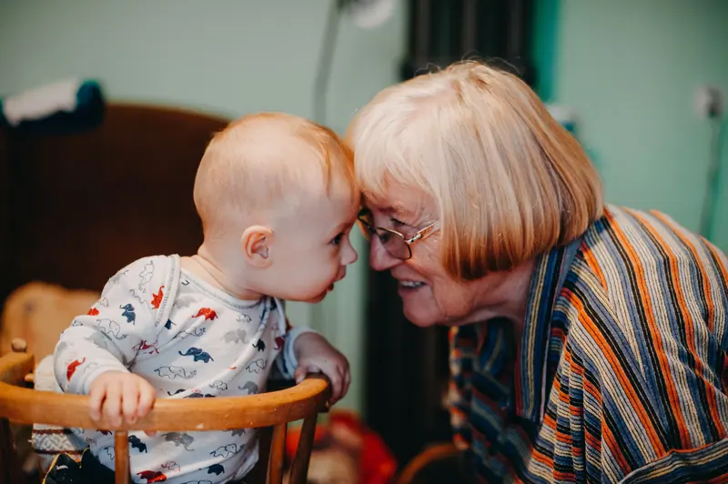 A resident meeting her newest great-grandchild