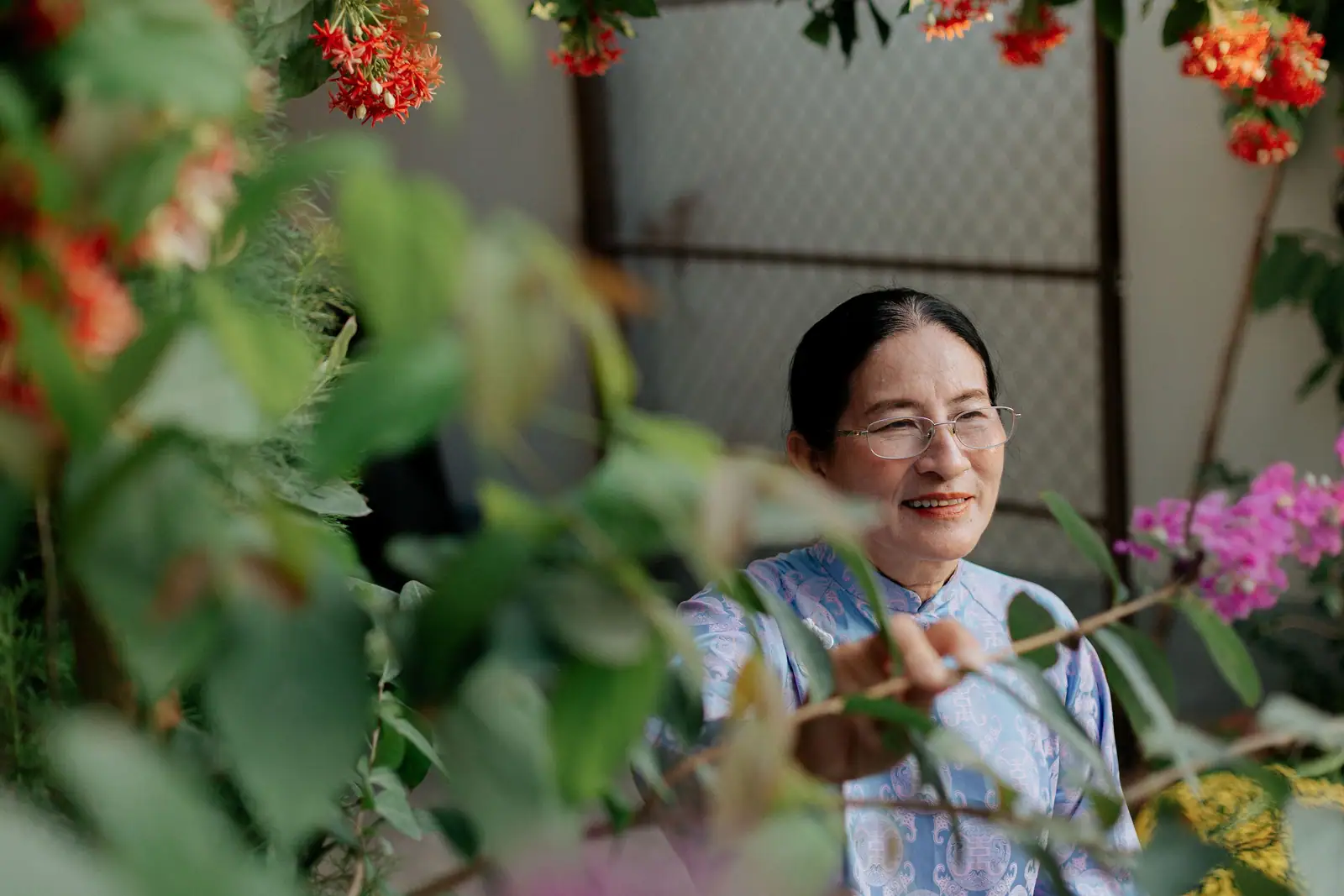 A resident smiling among the flowers