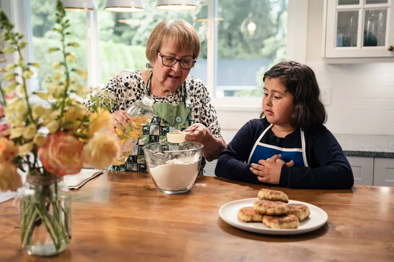 A resident baking with her granddaughter