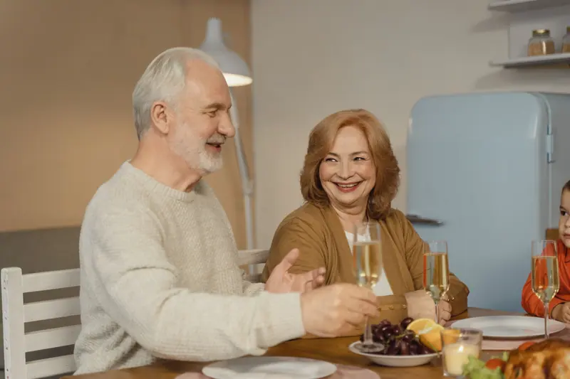 A couple celebrating their anniversary at Sunday dinner with family