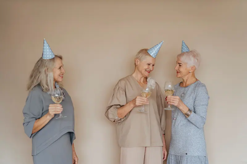 Residents in party hats toasting a birthday