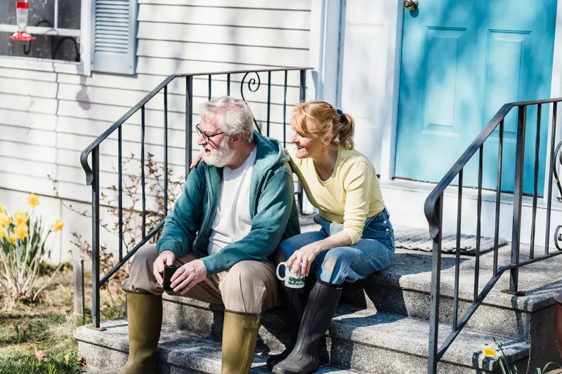 A resident and her daughter on the front steps with coffee