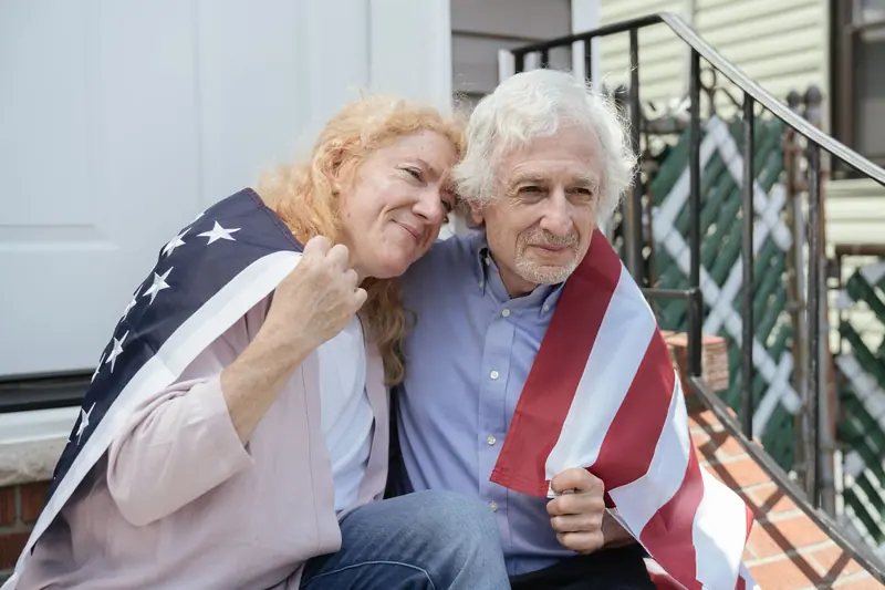 A couple in a flag on the Fourth of July