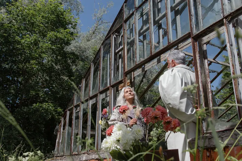 A couple admiring the greenhouse flowers