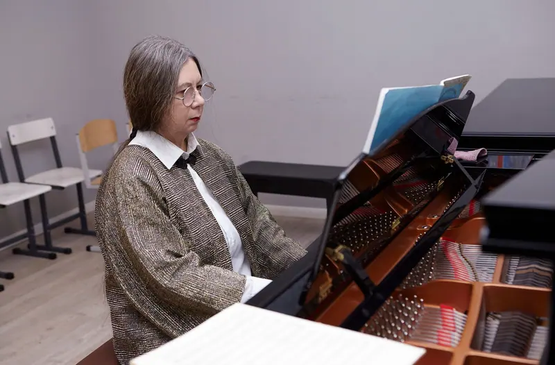 A resident reading through her score at the grand piano before the Thursday recital