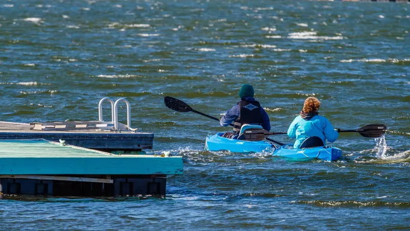 Residents launching kayaks from the swim dock