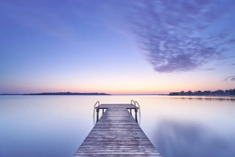 The dock at sunset, the lake calm and pink