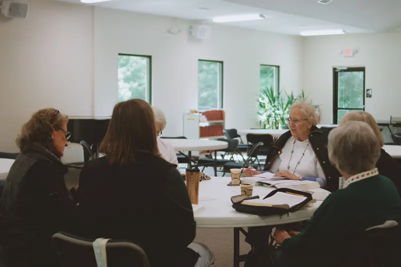 The Wednesday book club gathered around a table in the library