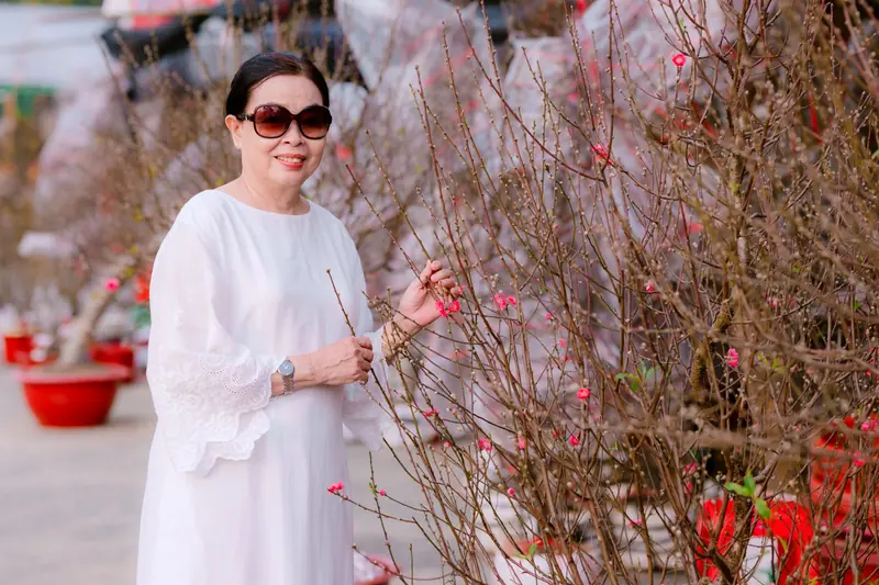 A resident in white among the blossoming branches