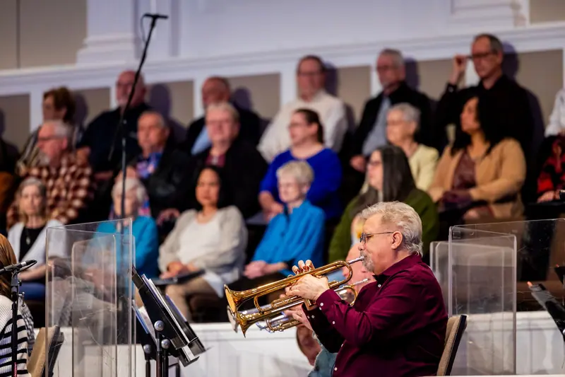 A resident on trumpet at a community jazz concert
