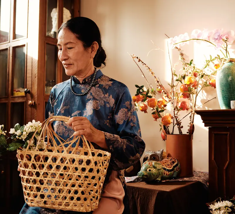 A resident carrying a basket of flowers to the dining room