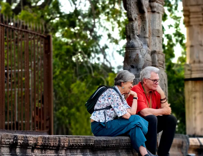 A couple resting on a stone wall