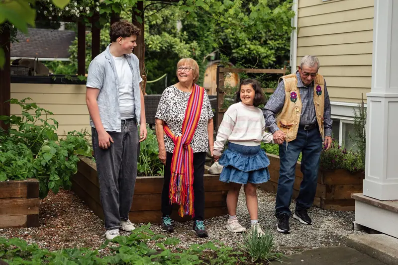 Grandparents showing the garden to their family on a Sunday visit