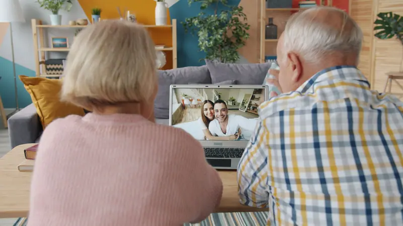 A couple on a video call with their family