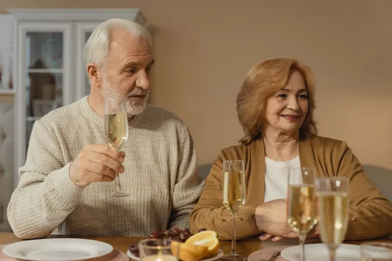 A husband and wife toasting with champagne at Sunday brunch