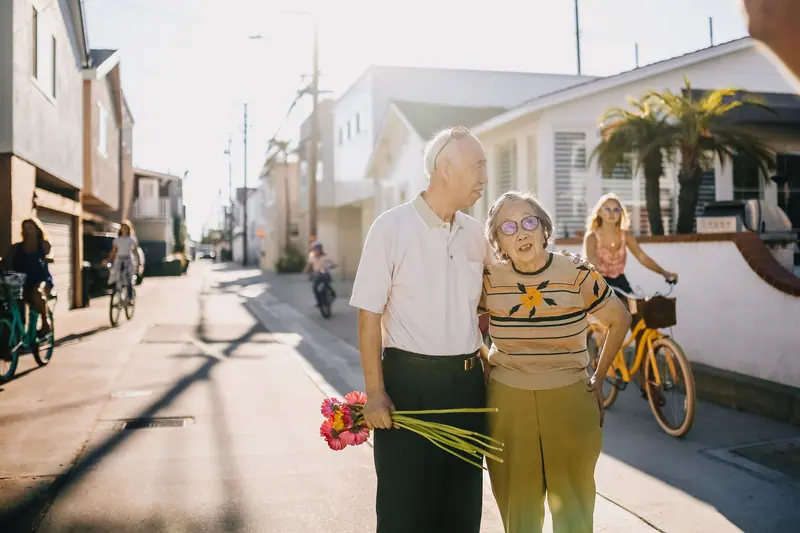 A couple walking home with flowers