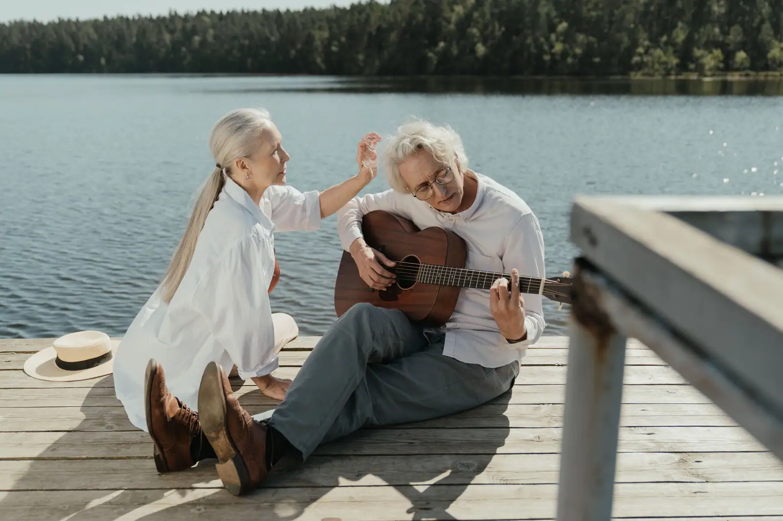 A resident couple on the dock, him playing guitar and her singing along