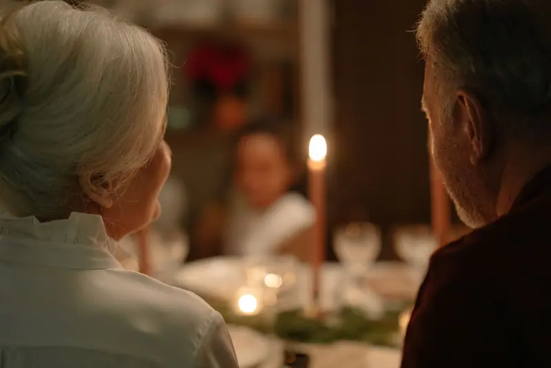 A holiday table with candles and family