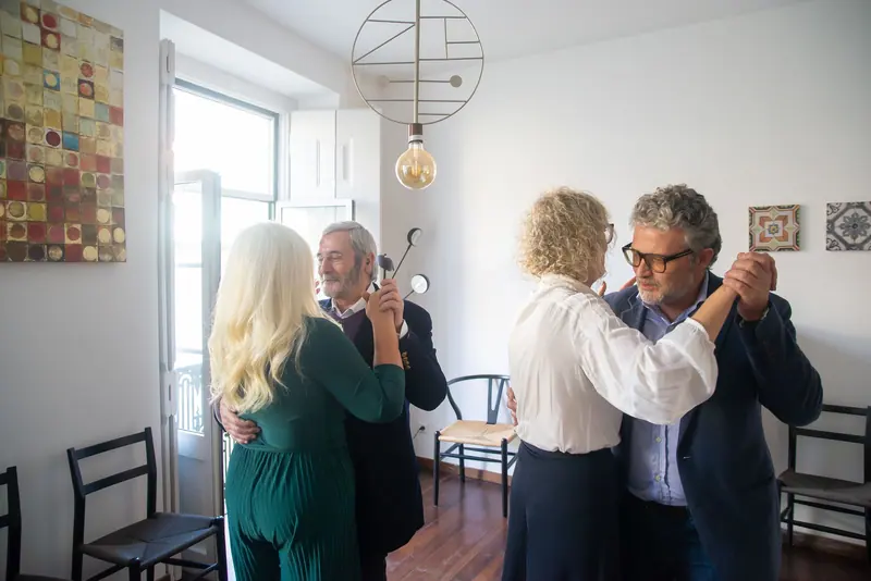 Two couples dancing in the clubhouse