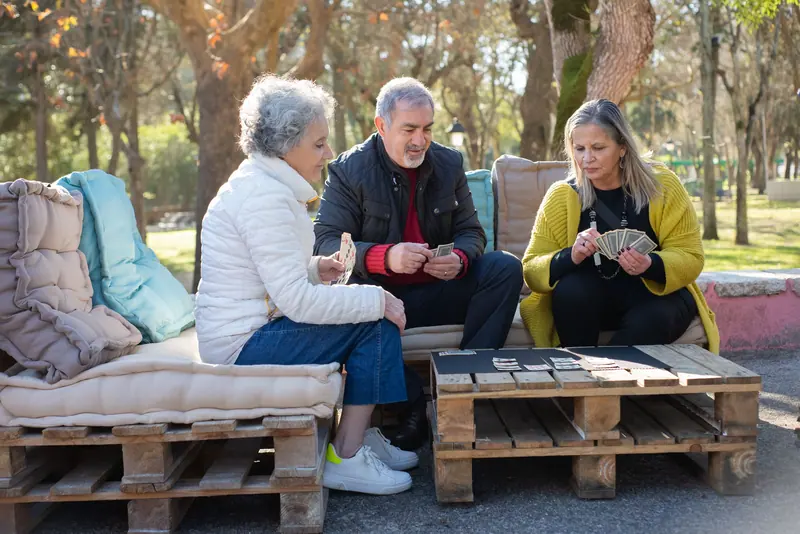 Neighbors playing cards on the lakeside patio