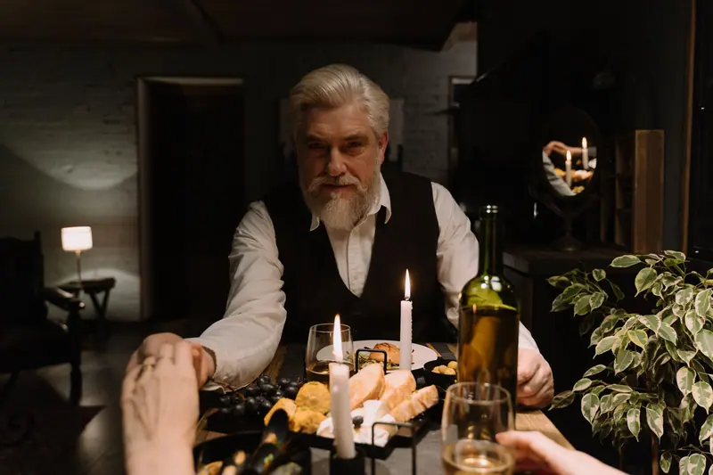 A resident lifting his glass toward his wife at supper