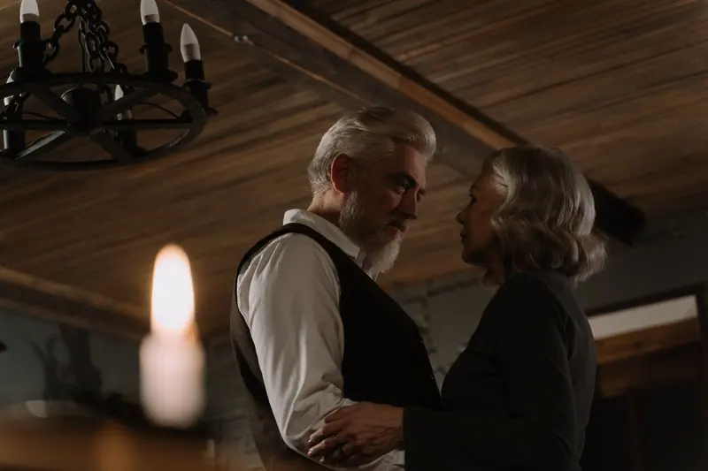 A couple dancing by candlelight in the parlor