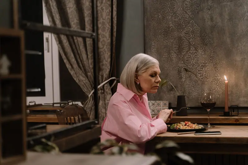A resident lingering over supper by candlelight