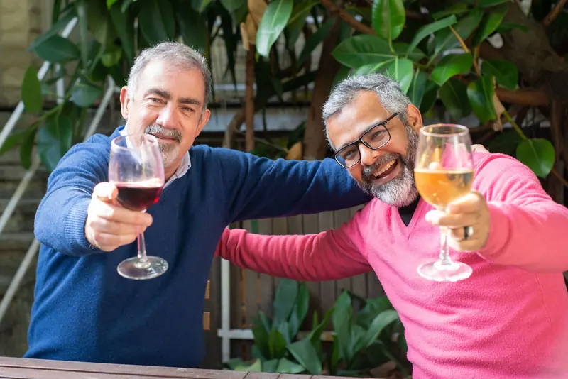 Two old friends raising a glass at Friday happy hour