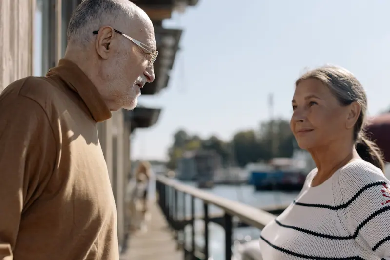 A couple smiling together beside the water
