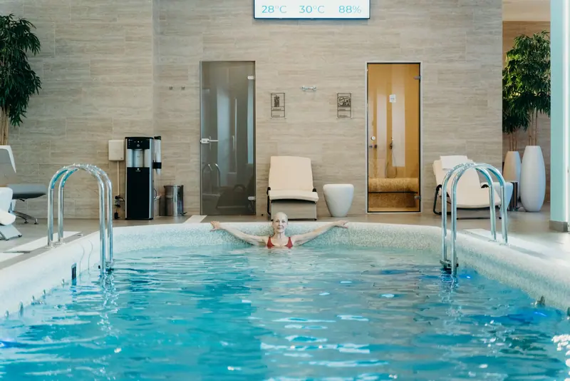 A resident swimming laps in the warm-water therapy pool