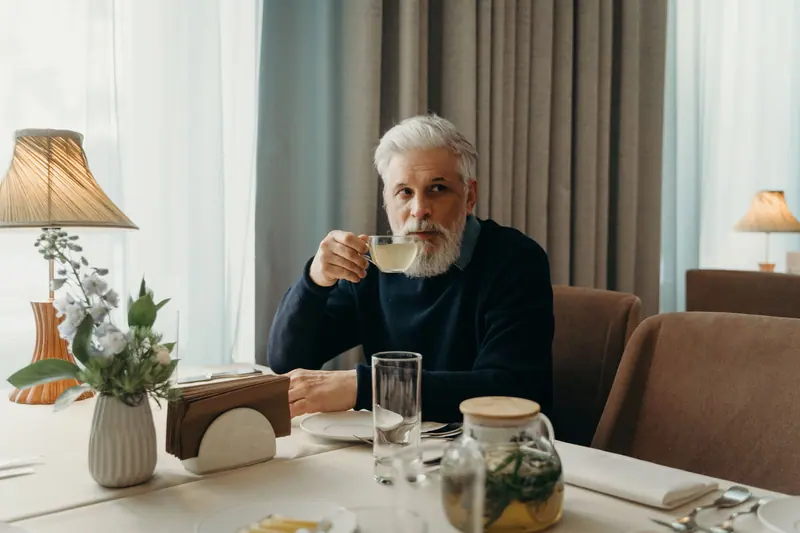 A resident lingering over coffee after breakfast