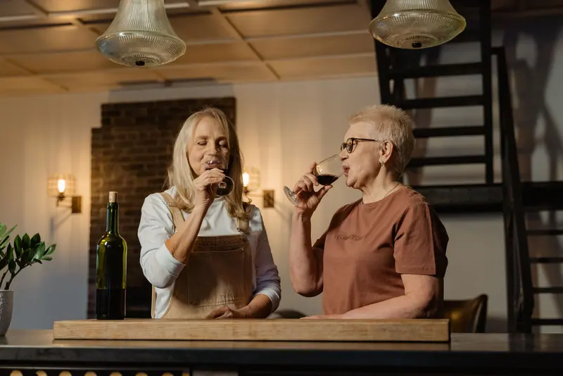 Two friends comparing a pour at the tasting bar