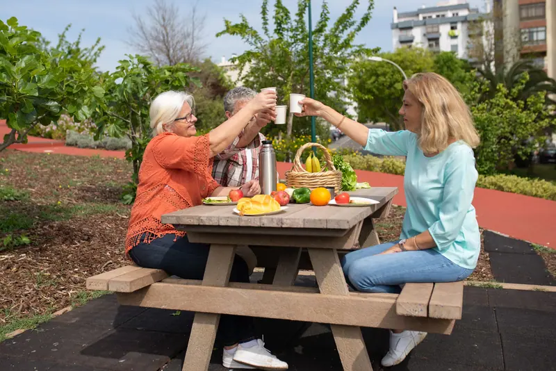 Residents toasting with lemonade at the garden picnic table