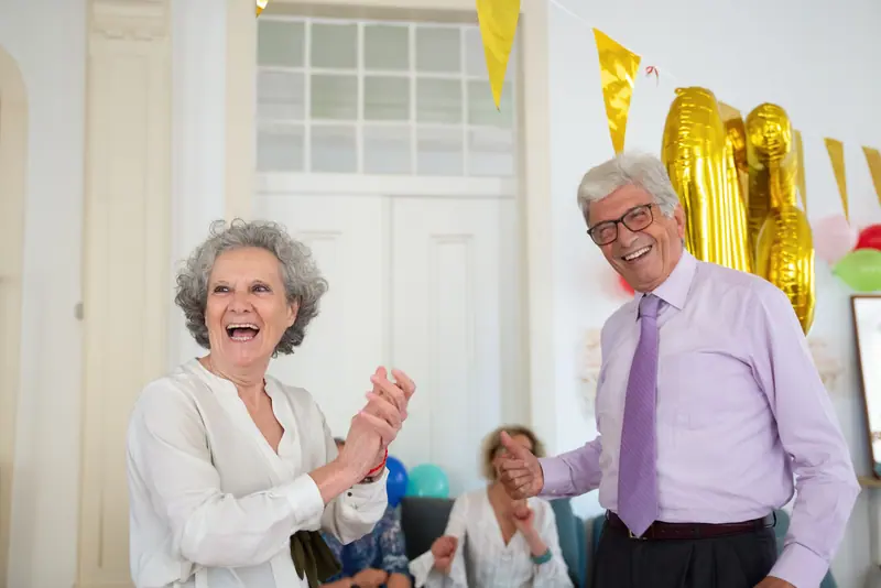 A resident laughing with a friend at the party