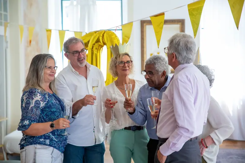 Friends raising glasses at a party in the activity room