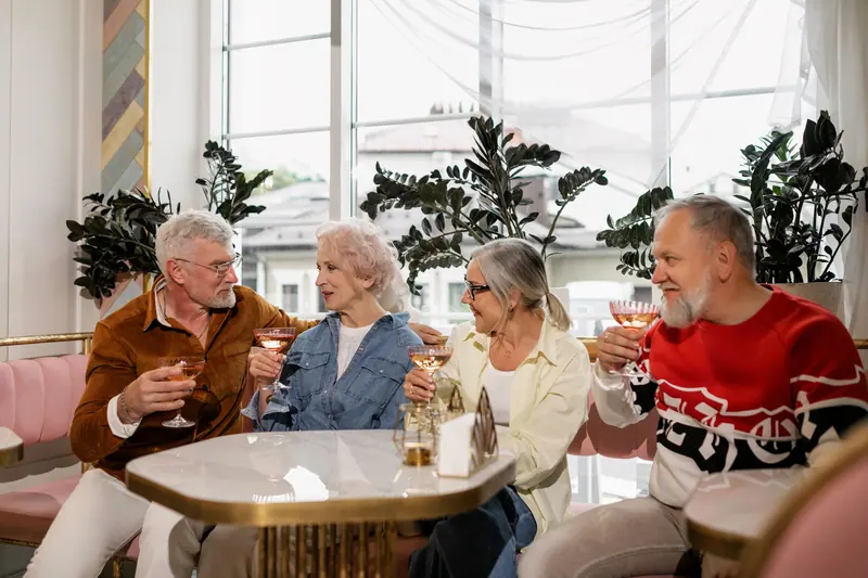 Four friends toasting at a café table on a Friday afternoon