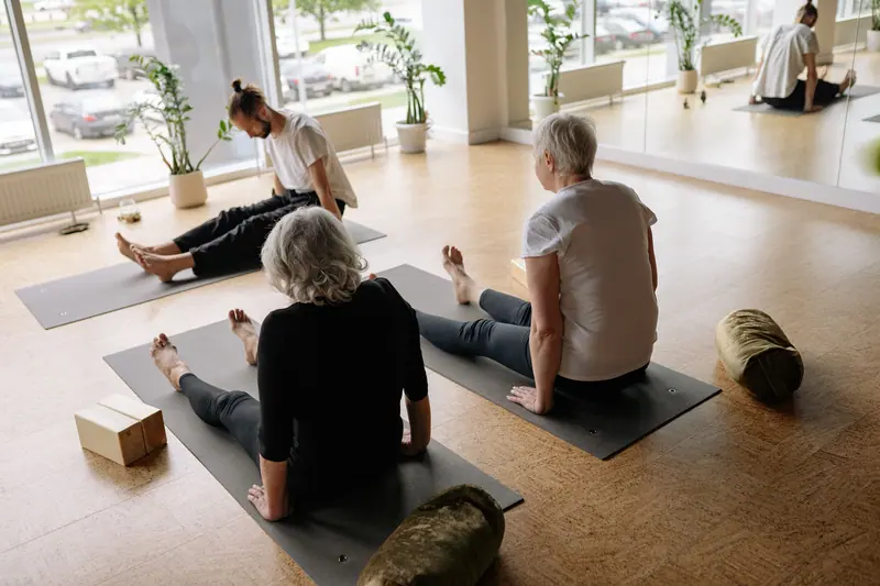 A stretching class on mats in the wellness room