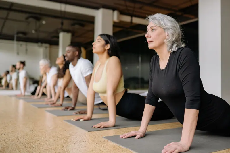 Residents in a row of downward dogs during yoga