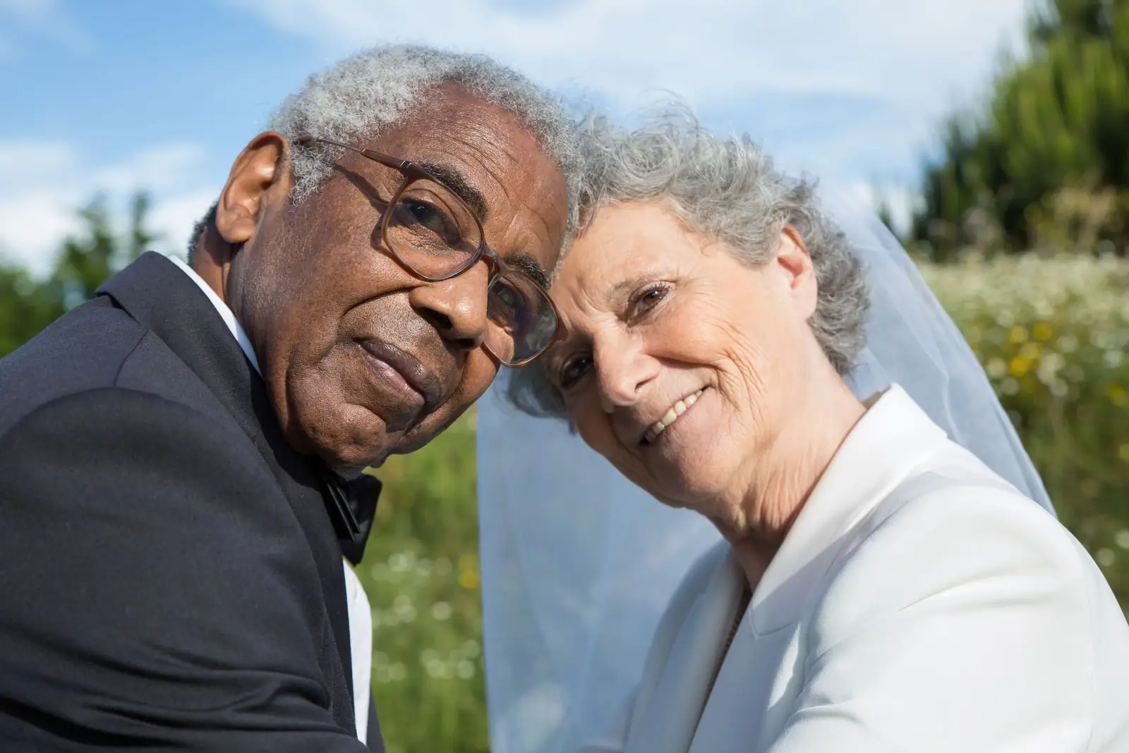 A resident couple cheek to cheek at their anniversary party