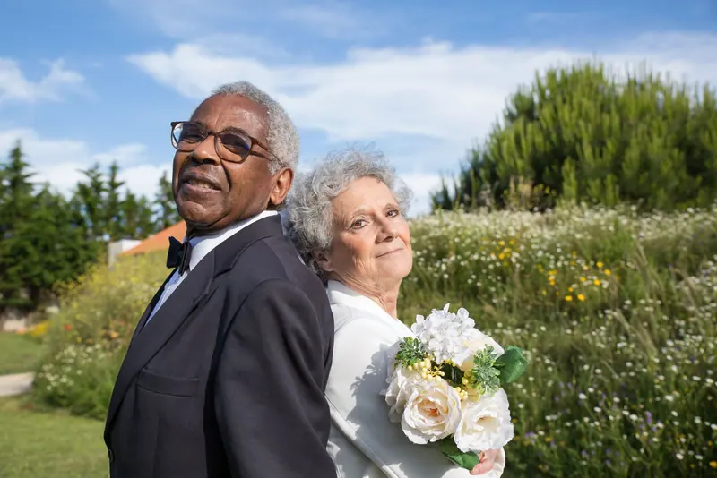 A couple in their Sunday best by the wildflowers