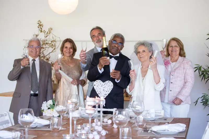 Family and friends toasting a couple's sixtieth anniversary