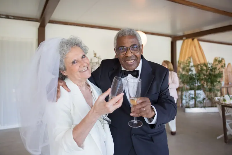A couple raising a glass at their anniversary supper