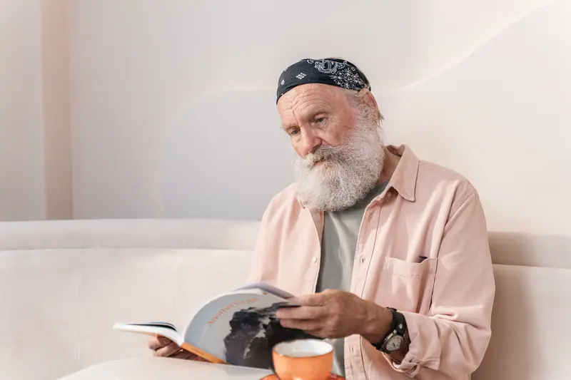 A resident reading on a white sofa in the morning room
