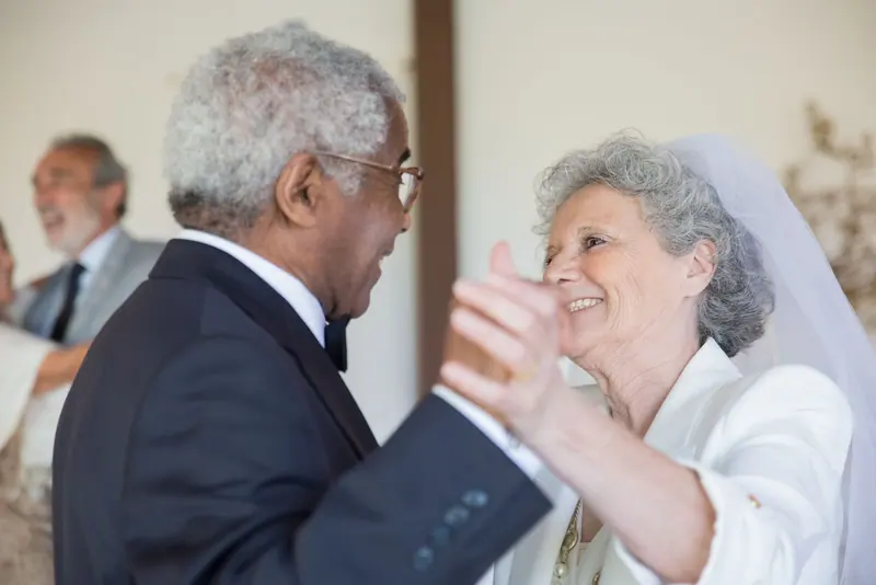 A couple dancing at their anniversary vow renewal in the parlor