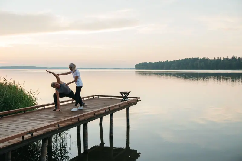 Chair yoga stretches on the dock at sunrise