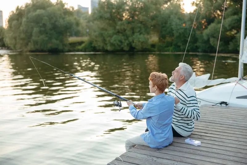 A resident teaching his grandson to cast off the end of the dock