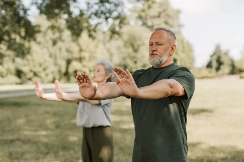Two residents doing tai chi on the lawn