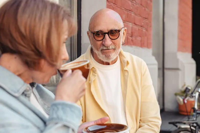 A couple sipping coffee outside the café downstairs
