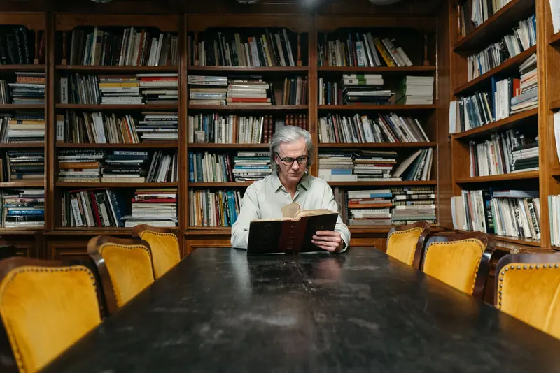 A resident reading in the paneled library